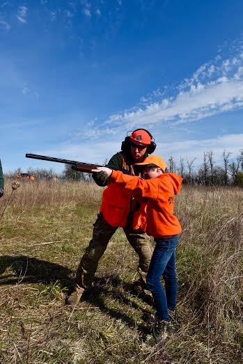 Kylyn Luckfield, a WOLF School participant receives proper shooting instruction from MDC resources assistant, Shawn Gamer.